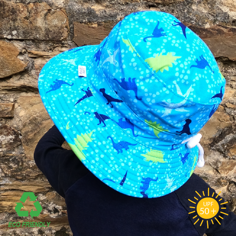 Kids sun hat with bold dinosaur print, wide brim for UV protection, breakaway chin strap, and eco-friendly recycled fabric for outdoor play