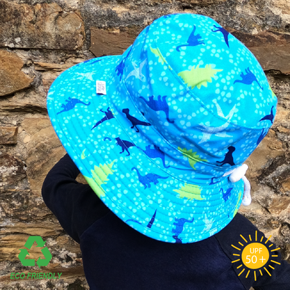 Eco-friendly kids bucket hat made from rPet fabric with vibrant dinosaur print, wide brim for all-day sun protection, and secure breakaway strap for active play.”