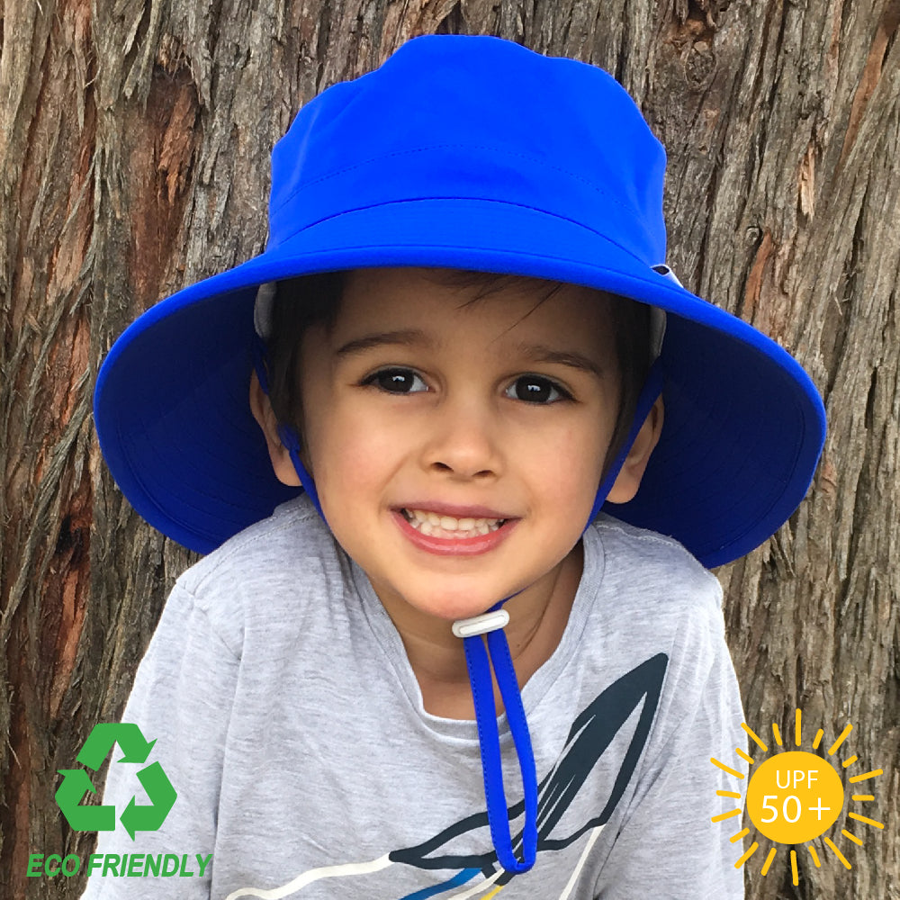 Kids bucket sun hat in solid royal blue with wide anti-flop brim, safety-release chin strap, and lightweight recycled polyester elastance fabric.